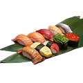 A close-up shot of a variety of Naeki's nigiri sushi pieces arranged on a green bamboo leaf. The sushi includes salmon, tuna, shrimp, mackerel, eel, egg, and salmon roe. The pieces are arranged in two rows, with the background being a solid black color.
