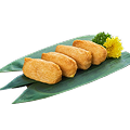 A. Alt Text: A close-up shot of four pieces of Naeki's inari sushi, also known as inarizushi, arranged on a green bamboo leaf. A sprig of green garnish and a yellow chrysanthemum are placed next to the sushi. The background is completely black, making the sushi stand out.