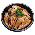 An overhead shot of a Naeki's Japanese bowl filled with white rice, topped with multiple thin, glistening slices of grilled eel (unagi). A sprig of green garnish is placed in the center. The bowl is black and rests on a solid black background.