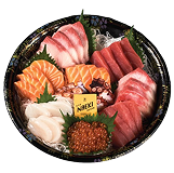 Naeki's platter of various sashimi is arranged on a black and gold decorative dish. The dish contains several types of raw seafood, including pink slices of tuna, pale orange salmon slices, white scallops, and dark red octopus pieces. A small yellow bottle of soy sauce is placed in the center of the platter, next to a pile of glistening orange salmon roe.